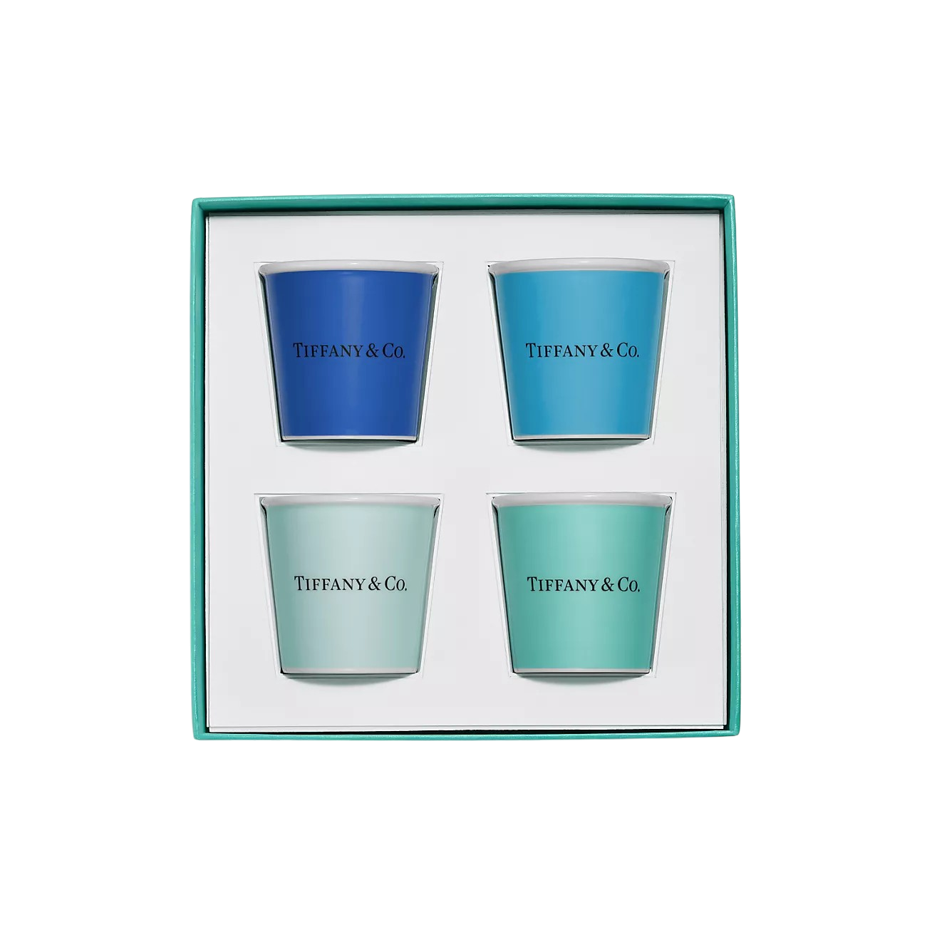 Set of four Tiffany & Co. votive candles in blue, light blue, pale mint, and teal in a turquoise gift box.