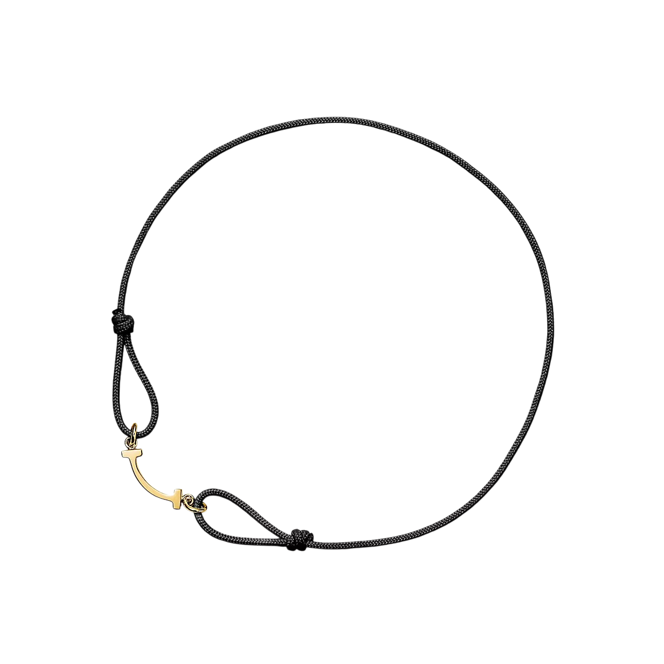Black cord bracelet with a gold-tone curved clasp, arranged in a circular shape with knot details.