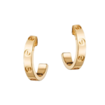 Gold hoop earrings with screw-detailed design floating on black background.