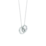 Silver necklace with an interlocking rings pendant hanging from a delicate chain.
