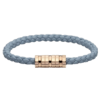 Blue braided bracelet with a gold-toned central clasp set against a black background.