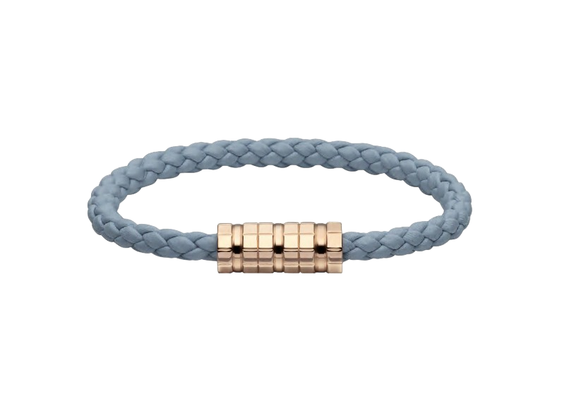 Blue braided bracelet with a gold-toned central clasp set against a black background.