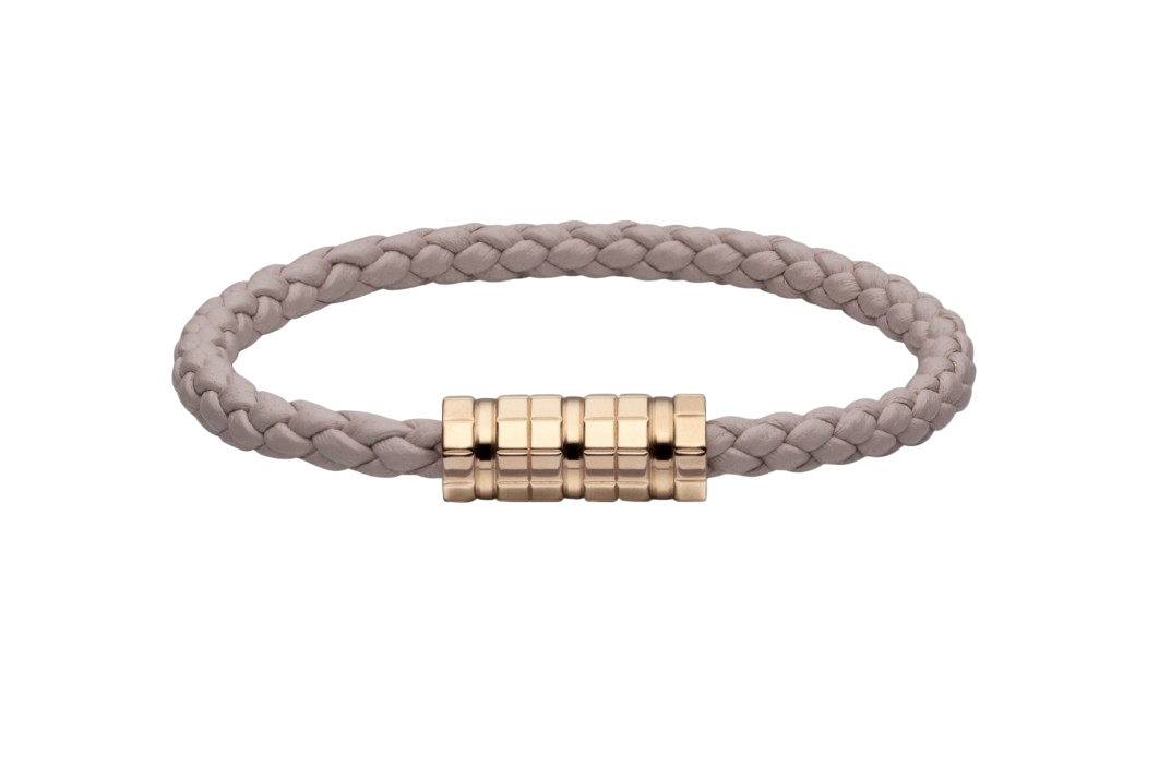 Beige braided cord bracelet with a gold segmented cylindrical clasp on black background.