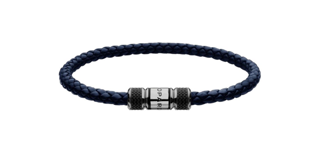 Blue braided leather bracelet with a silver cylindrical clasp centered on a black background, close-up view.