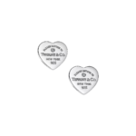 Two silver heart-shaped charms engraved with 'Please return to Tiffany & Co. New York 925'.
