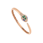 Rose gold snake-inspired bracelet with a diamond-studded head and green and blue gemstone accents