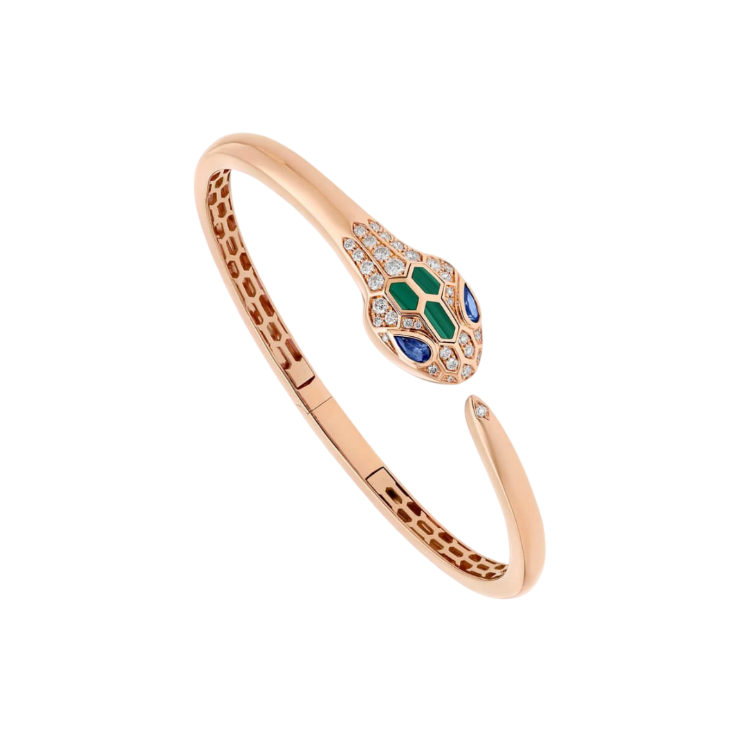 Rose gold snake-inspired bracelet with a diamond-studded head and green and blue gemstone accents