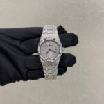Diamond-encrusted wristwatch on a gloved hand, silver metallic band and sparkling dial.