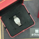 Silver wristwatch with a metal link bracelet displayed in an open red presentation box with a black interior.