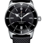 Breitling Superocean automatic wristwatch with black dial, date window, and textured black strap on a dark background.