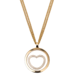 Gold circular pendant on a gold chain featuring a diamond-studded heart in the center against a black background.