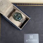 Breitling wristwatch in a beige suede presentation box with a green dial and date window