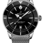 Breitling SuperOcean dive watch with black dial, silver hands, unidirectional bezel, and stainless steel mesh bracelet.
