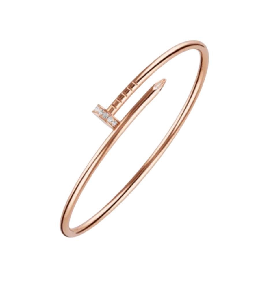 Rose gold open bangle bracelet with a small diamond-studded bar accent on a black background