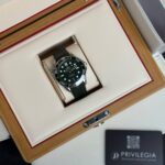 Omega dive watch with black dial in a wooden presentation box lined in cream, Privilegia card nearby