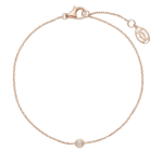 Rose gold bracelet with a single round diamond bezel-set centerpiece on a thin chain, with a lobster clasp against a black background.