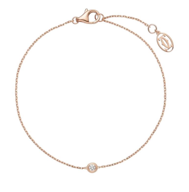 Rose gold bracelet with a single round diamond bezel-set centerpiece on a thin chain, with a lobster clasp against a black background.
