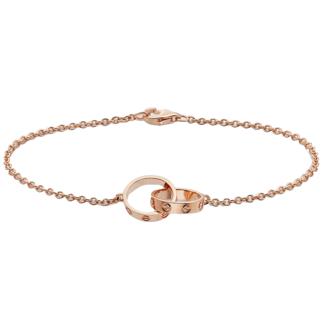 Rose gold chain bracelet with an interlocking ring clasp on a black background.