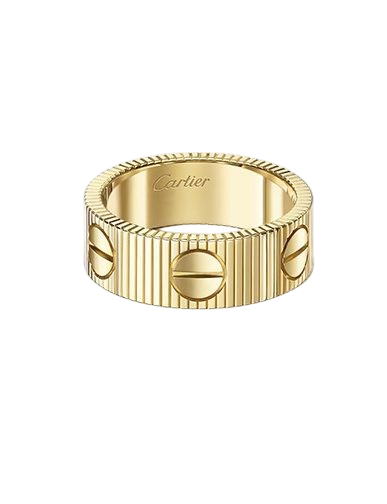 Gold Cartier ring with a ribbed band and screw-head motifs.