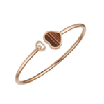 Rose gold bracelet with two heart charms, one small diamond-studded, another striped brown inlay heart