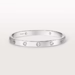 Silver Cartier bracelet: a sleek, round bangle with evenly spaced diamond settings along its band.