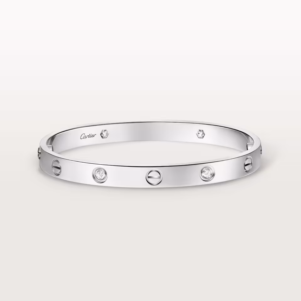 Silver Cartier bracelet: a sleek, round bangle with evenly spaced diamond settings along its band.