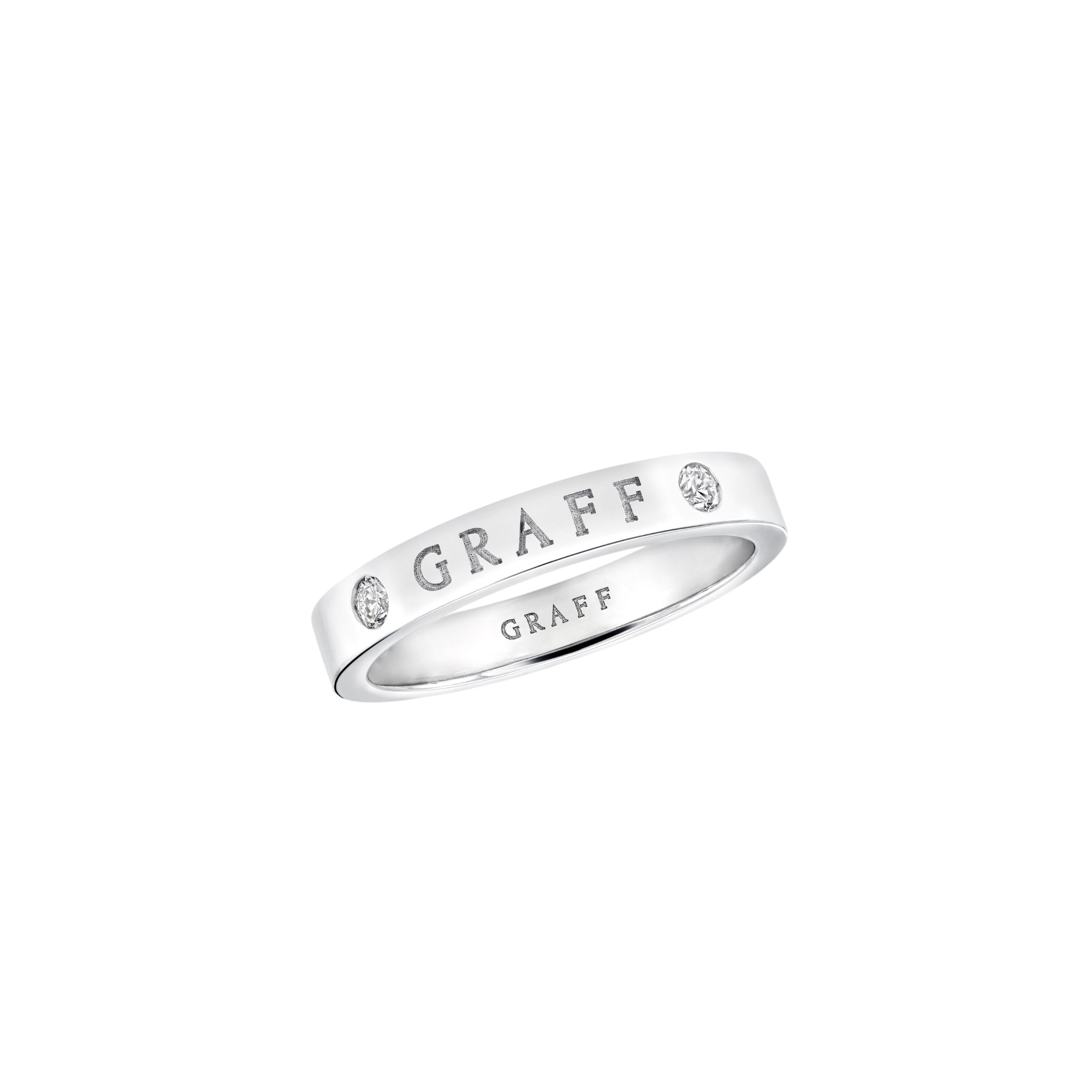 Close-up of a white-gold ring with diamonds set along the band and 'GRAFF' engraving visible across the metal.
