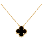 Gold chain necklace with a black clover-shaped pendant outlined by a beaded gold edge on a black background.