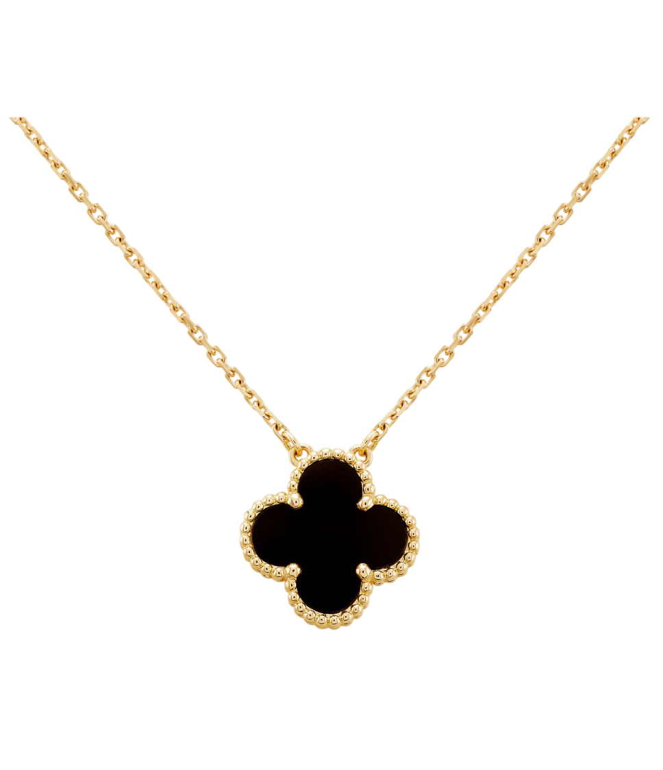 Gold chain necklace with a black clover-shaped pendant outlined by a beaded gold edge on a black background.