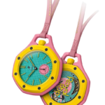 Two colorful wristwatches with pink cases, yellow bezels, turquoise dials, pink straps, overlapping on a black background.